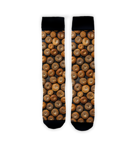 Flatlay product shot of two Bagels 360 socks against a white background. The socks are positioned vertically, showing the full bagel print.