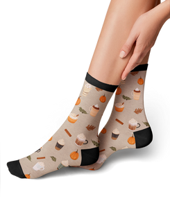 Lifestyle shot of a model wearing Pumpkin Spice Latte socks, showing how they look on.