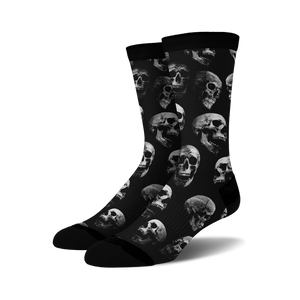 Pair of black crew socks with a repeating grayscale skull pattern.  Edgy and stylish.