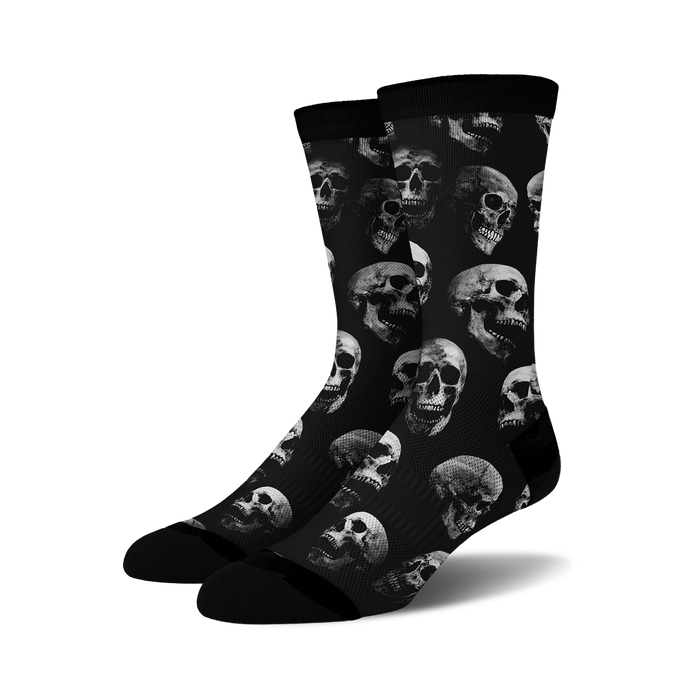Pair of black crew socks with a repeating grayscale skull pattern.  Edgy and stylish.