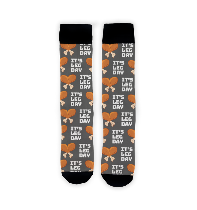 A pair of gray socks with a pattern of cartoon turkey legs and the words 