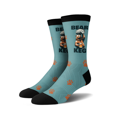 A pair of crew socks; teal blue with a brown bear lifting a keg of beer, orange paw prints, and black cuffs.