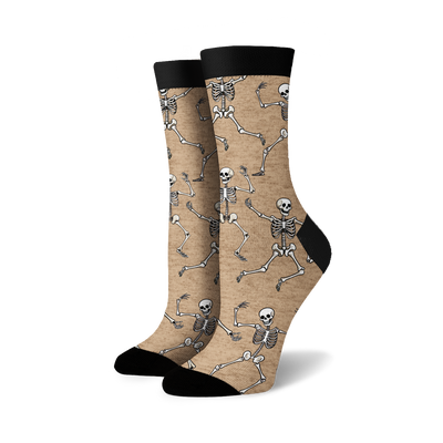 Pair of crew socks; beige and black options; dancing skeleton pattern.