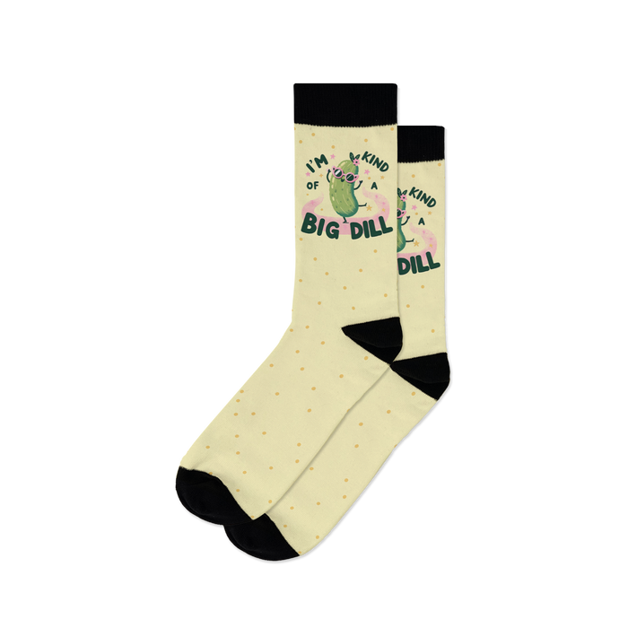 Pair of pastel yellow crew socks with a cool pickle graphic and the text 'I'm kind of a big dill'.  Small yellow dots are scattered across the sock.