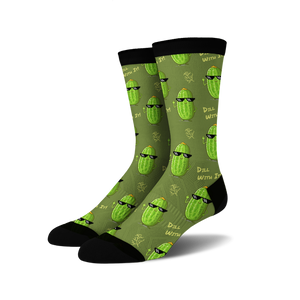 Pair of crew socks in olive green with repeating pattern of cartoon pickles wearing sunglasses and making a hand gesture.