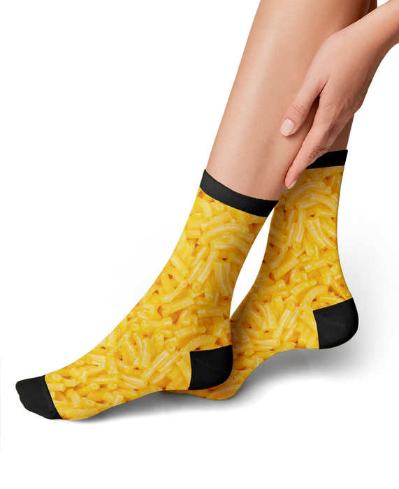 Close-up flatlay showcasing the detailed mac and cheese print on the Mac & Cheese 360 socks.