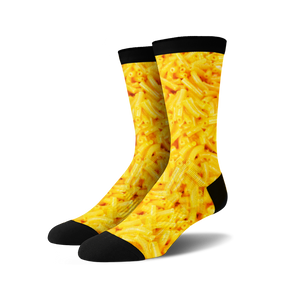 Pair of crew socks with an all-over print of macaroni and cheese in shades of yellow and black.