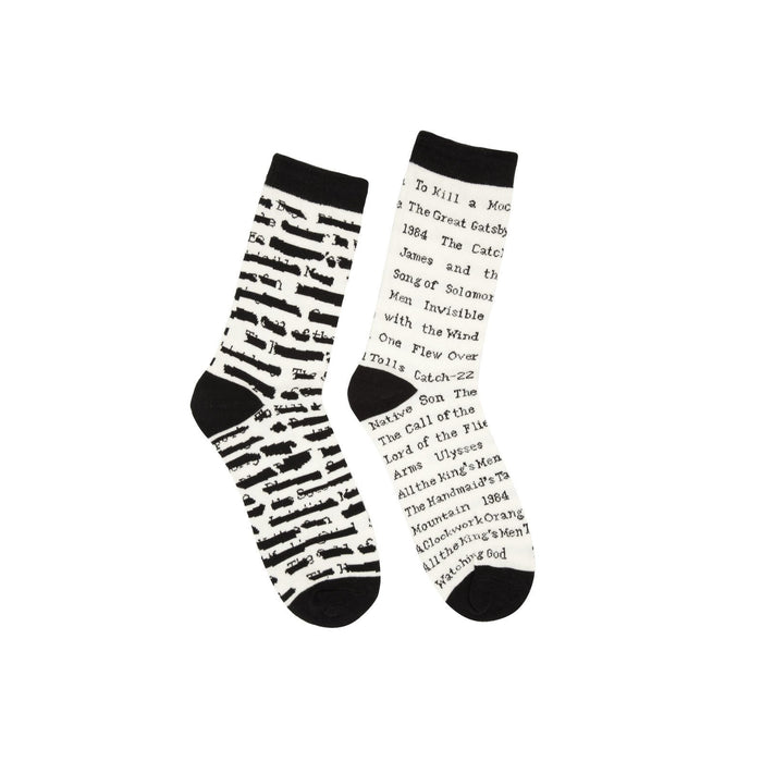 Pair of cream crew socks with black stripes and text. Titles of banned books are printed on the socks, including 'To Kill a Mockingbird' and '1984'. }}