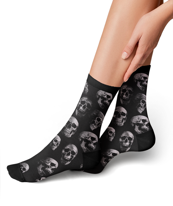 Lifestyle shot: person's legs wearing the skull socks, showing the fit and style.