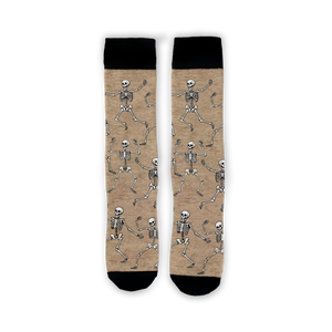 Flatlay image showing a pair of tan 'Dead Man's Party' socks with dancing skeletons.
