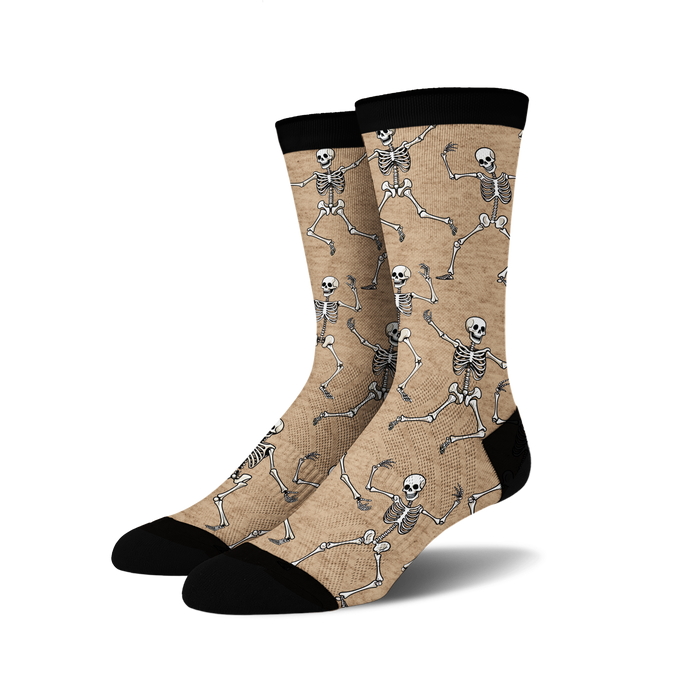 Pair of tan crew socks with a fun all-over print of dancing skeletons in off-white.