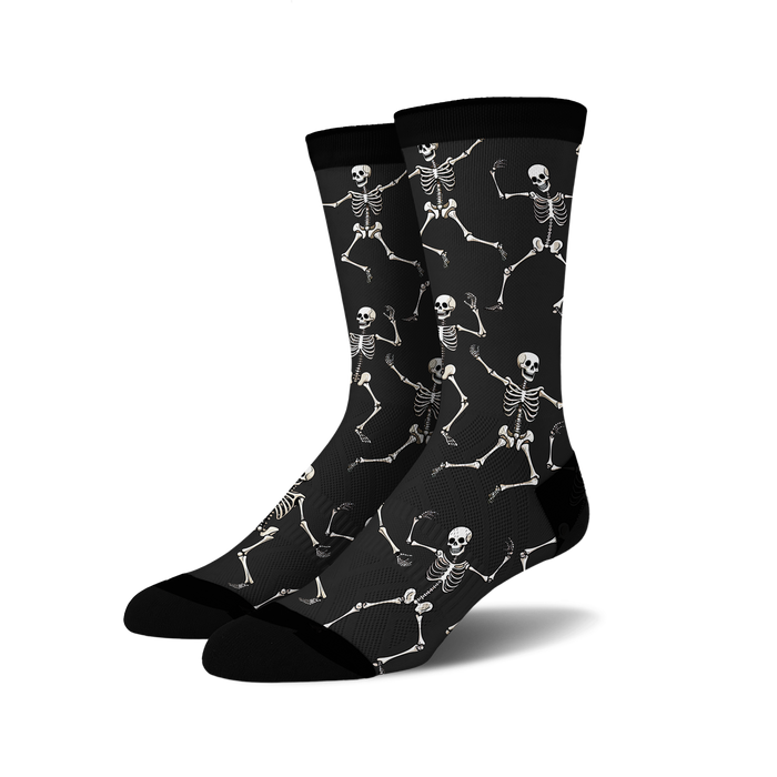 Pair of black crew socks with a fun all-over print of dancing skeletons in off-white.