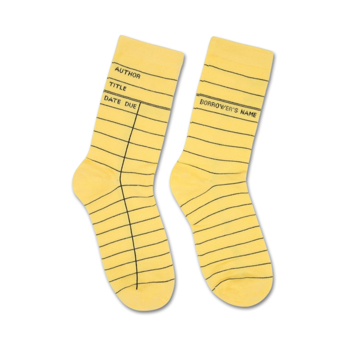 Pair of pastel yellow crew socks featuring a library card design with black lines and text. }}