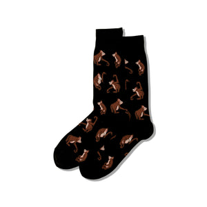 Pair of crew socks, black with brown orangutan pattern.  Second image shows olive green socks with same design.