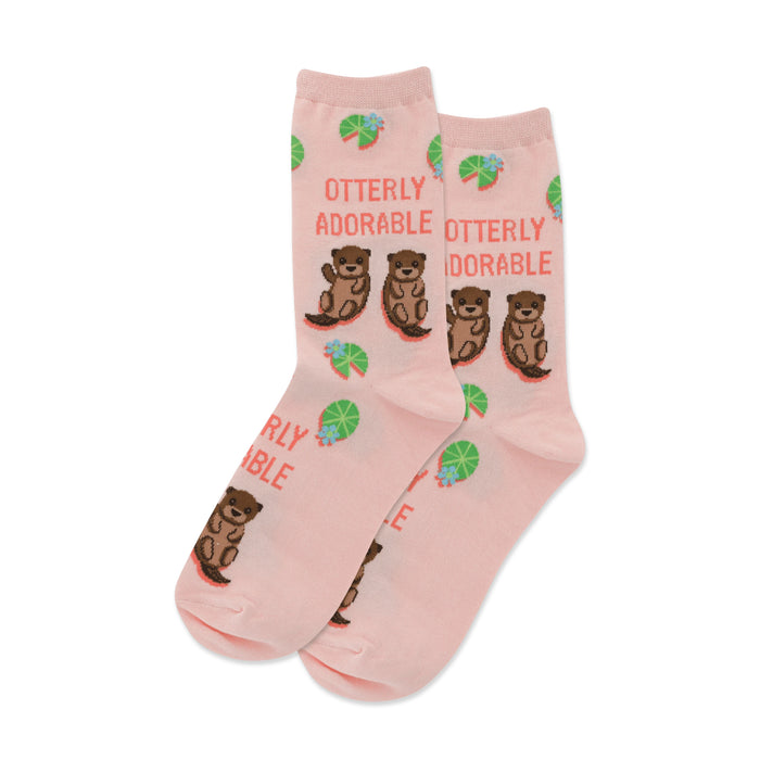 Pair of pink crew socks. Features a repeating pattern of brown otters, teal lily pads, and the text 'Otterly Adorable'. }}