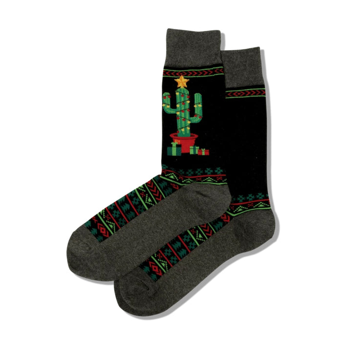 Pair of Christmas Cactus Non-Skid Slipper socks. Black with a decorated cactus image, geometric patterns, and grey cuffs.