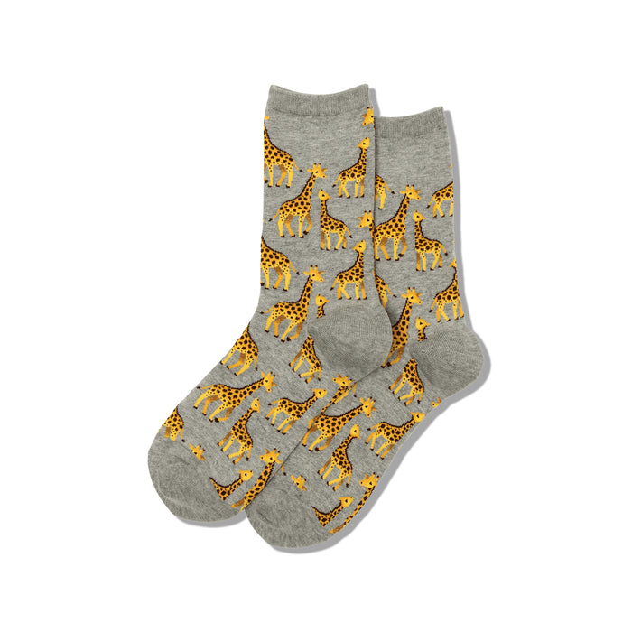 Pair of grey crew socks with a repeating pattern of yellow and brown giraffes of varying sizes. }}