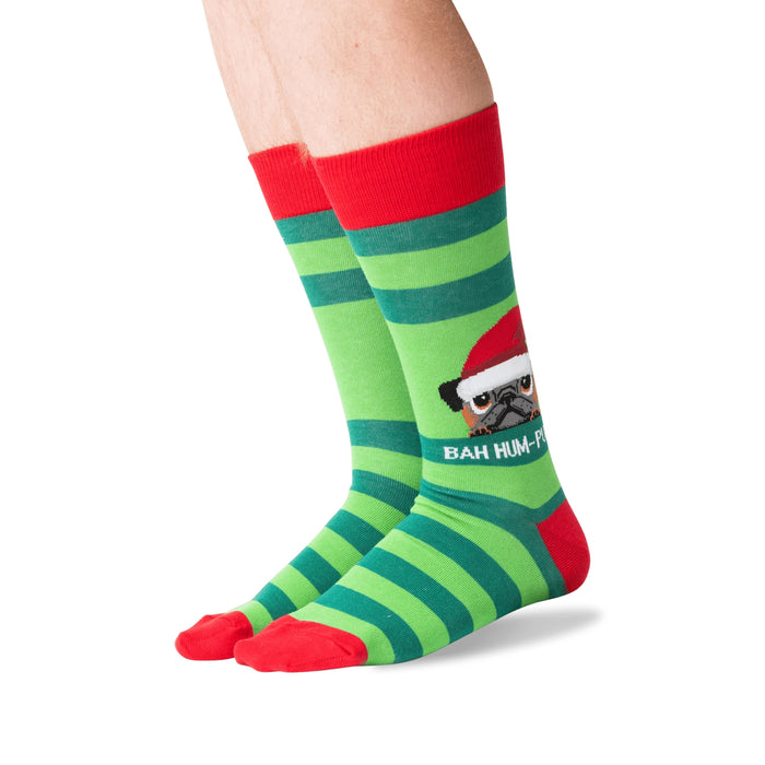 Lifestyle shot showing the socks on a person's feet.  The socks are green and red striped with a pug graphic.