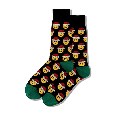 Pair of black crew socks featuring a repeating pattern of yellow smiling emojis wearing Santa hats. Green cuffs.