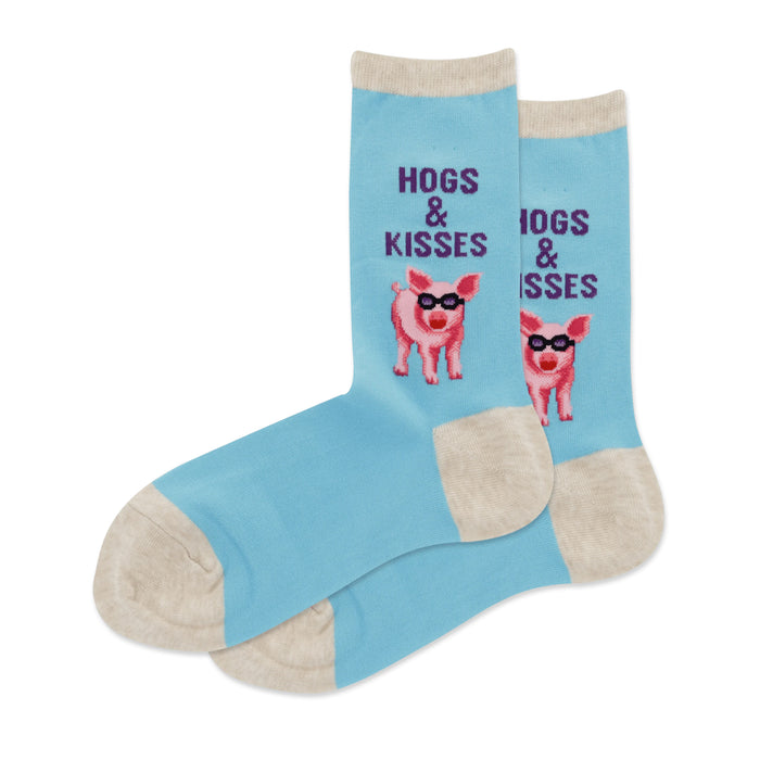 Pair of light blue crew socks with a pattern of pink pigs wearing sunglasses and the text 'Hogs & Kisses'. }}