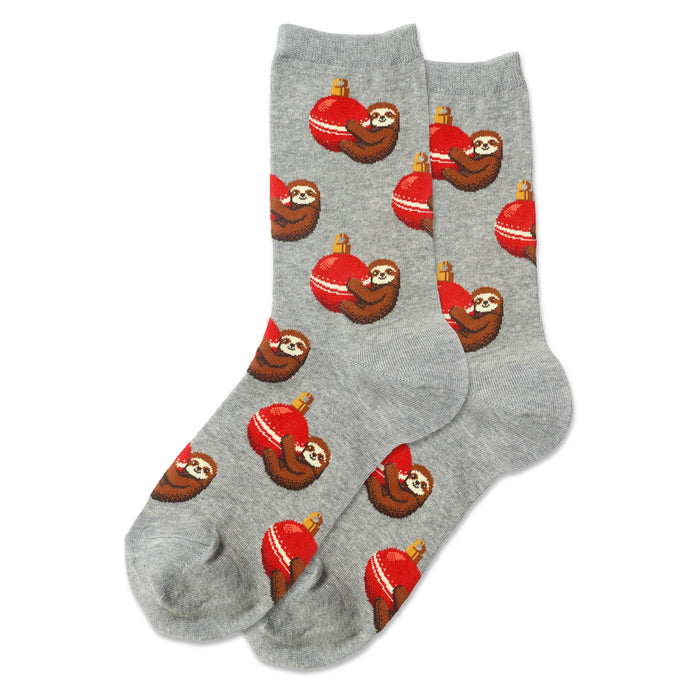 Pair of crew socks, heather gray, featuring a repeating pattern of pixelated sloths hugging red Christmas ornaments.