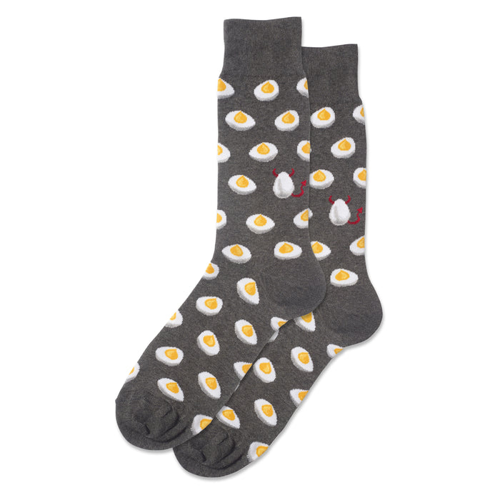 A pair of dark gray crew socks with a repeating pattern of yellow deviled eggs. Two eggs have small red devil horns and tails. }}