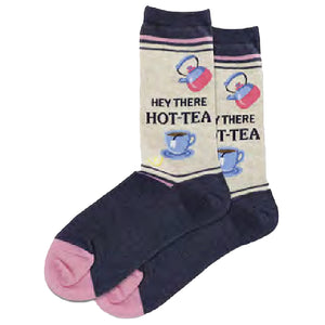 Cream-colored crew socks with navy blue feet and pink toes. Features a repeating pattern of teapots, teacups, and the phrase 'Hey There HOT-TEA'.