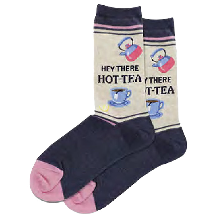 Cream-colored crew socks with navy blue feet and pink toes. Features a repeating pattern of teapots, teacups, and the phrase 'Hey There HOT-TEA'.