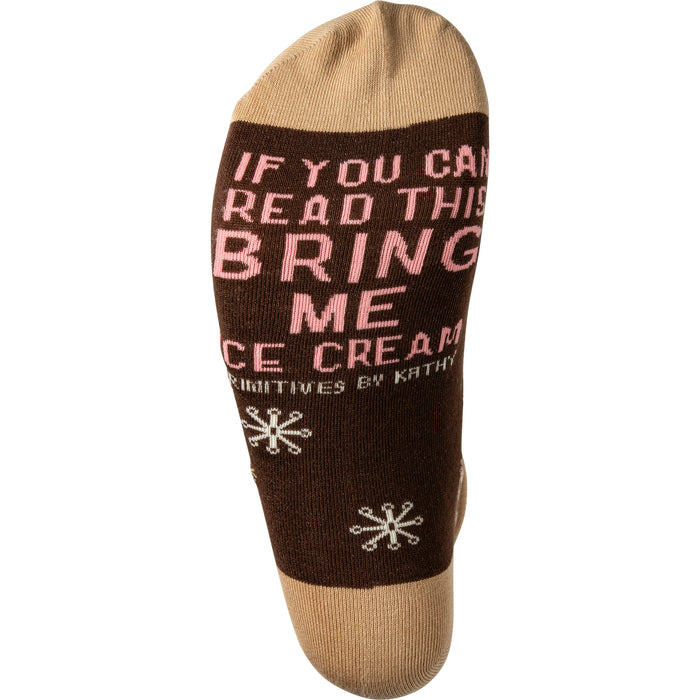 Close-up of the sock bottom, showing the text 'If you can read this bring me ice cream' in pink.