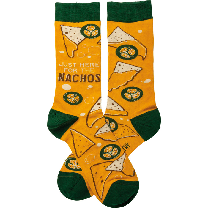 Crew socks in mustard yellow with a nacho pattern, including tortilla chips, cheese, and jalapeños.  Cuffs are dark green. }}