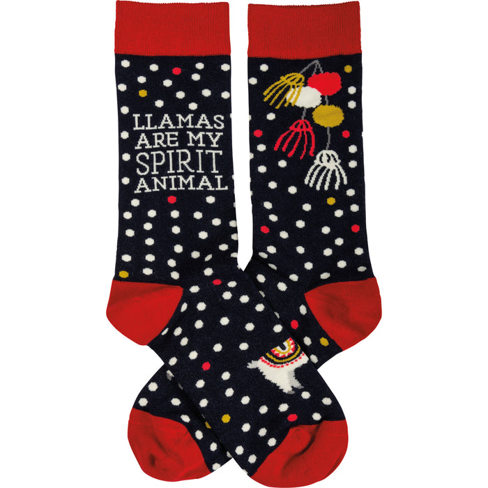 A pair of navy blue crew socks with white polka dots and red cuffs.  One sock features a llama and the text 'Llamas Are My Spirit Animal'. }}
