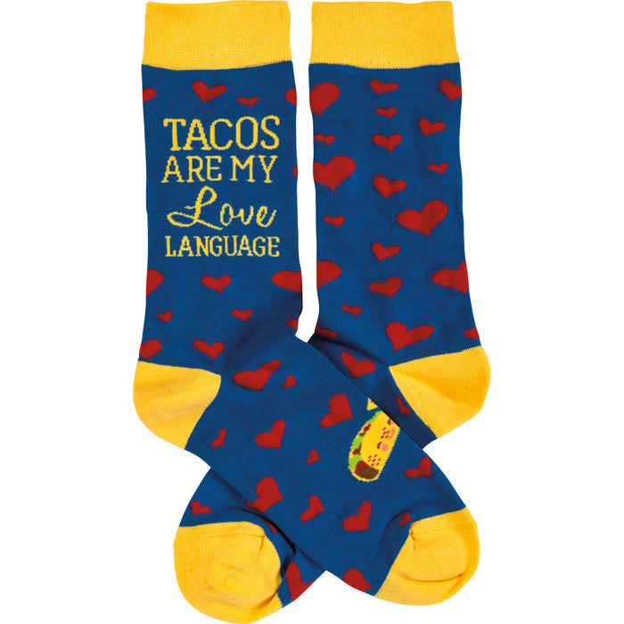 Crew socks in blue with red hearts and yellow cuffs.  The text 'Tacos Are My Love Language' is visible on one sock. }}