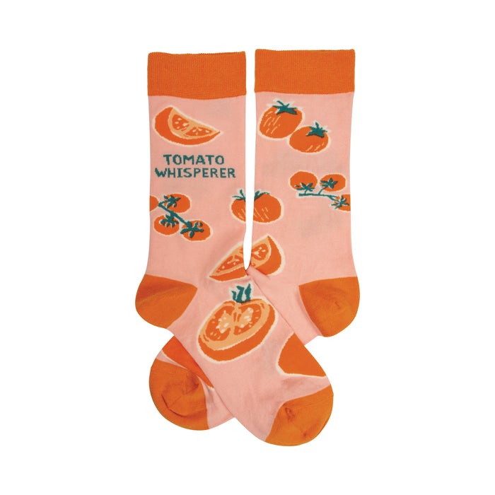 Pair of pink crew socks with an orange tomato pattern and the text 'Tomato Whisperer'. }}
