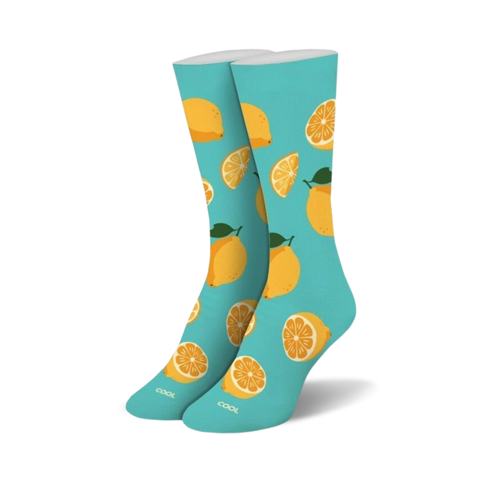 Pair of crew socks. Light teal background with a pattern of yellow lemons and lemon slices.