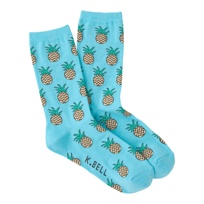 Pair of light blue crew socks with a repeating pattern of brown and green zig-zag pineapples. }}