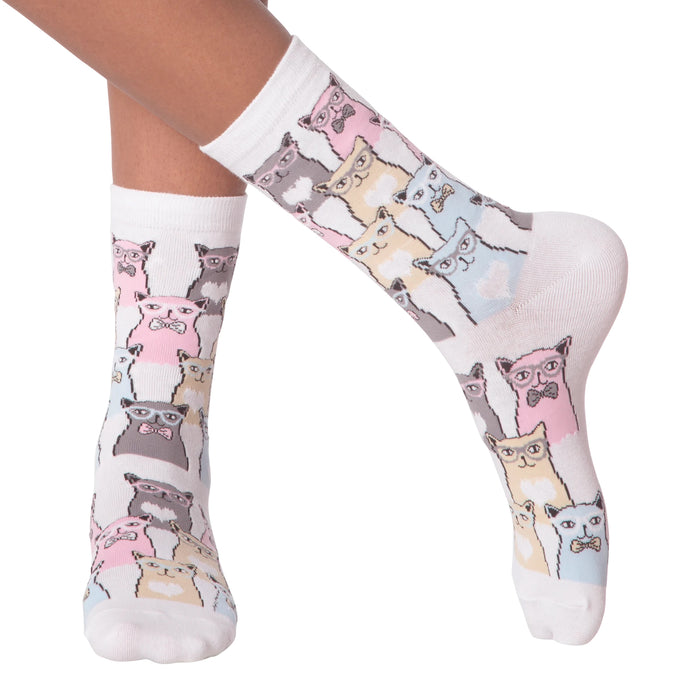 Close-up of a person's legs wearing white Smarty Cats socks.