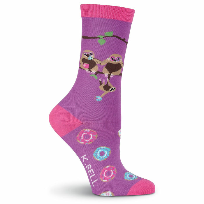 Purple crew socks with pink accents.  The design includes three sloths hanging on a branch and scattered donuts. }}