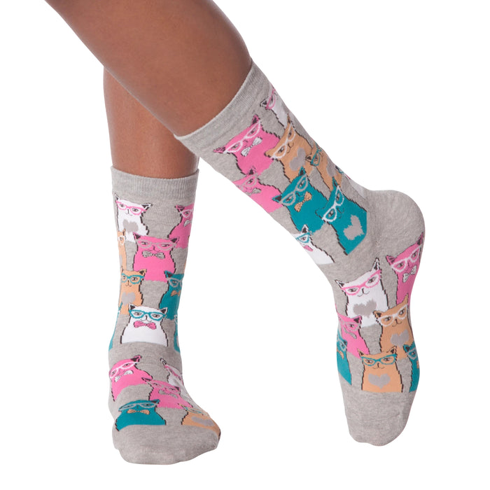 Close-up of a person's legs wearing grey Smarty Cats socks.
