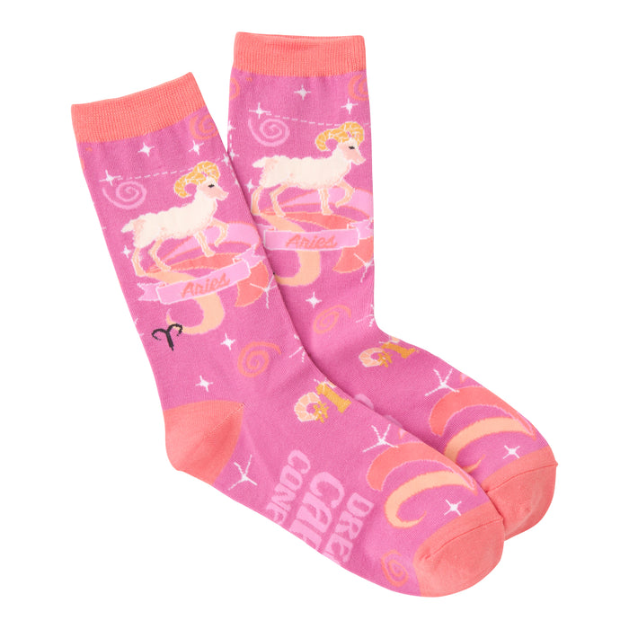 Pair of pink crew socks with an Aries zodiac theme. Features rams, stars, and swirling designs in shades of pink and orange. }}