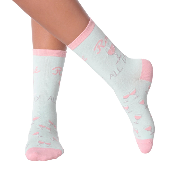 Lifestyle shot of woman's legs wearing 'Rose All Day' socks.