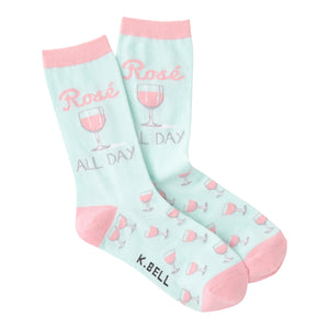 Pair of pastel pink and mint green crew socks.  Design features 'Rose All Day' text and pink rosé glasses.