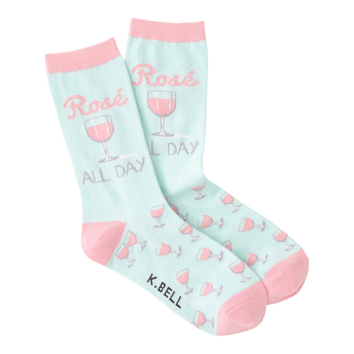 Pair of pastel pink and mint green crew socks.  Design features 'Rose All Day' text and pink rosé glasses.