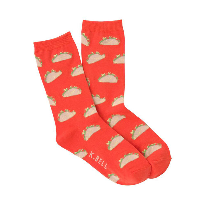 A pair of orange crew socks featuring a repeating pattern of small, illustrated tacos. The tacos are light brown with green and tan details. }}