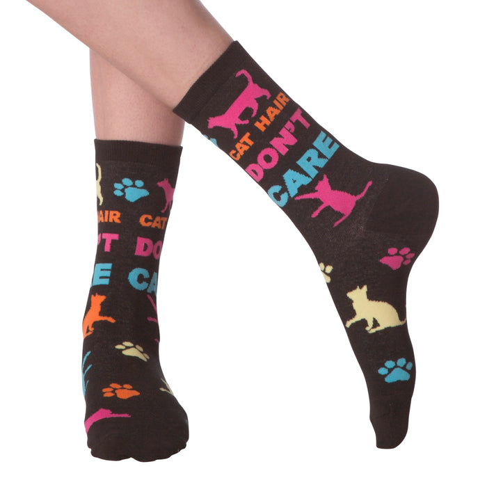 Lifestyle shot of a person wearing the 'Cat Hair Don't Care' socks. The socks are shown from the ankle to mid-calf.
