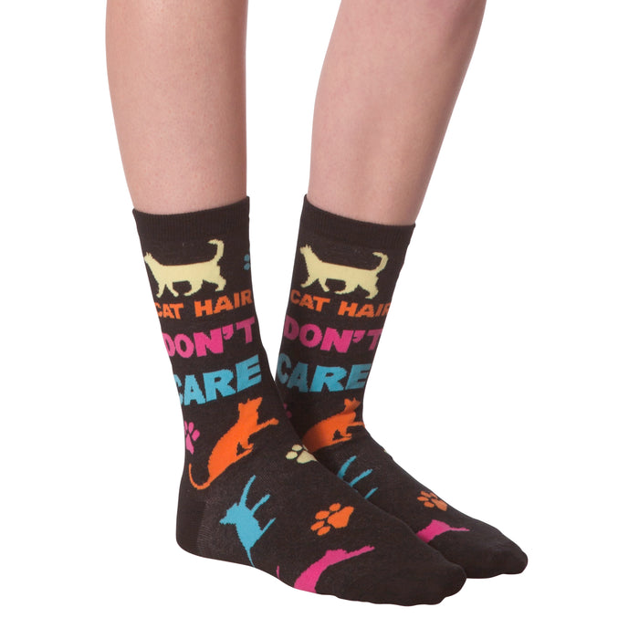 Flat lay shot of a pair of 'Cat Hair Don't Care' socks. The image highlights the sock's design and pattern.