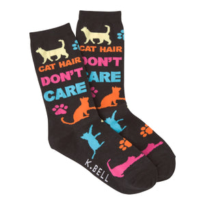 A pair of dark-colored crew socks with a playful design. The socks feature colorful cat silhouettes, paw prints, and the text 'Cat Hair Don't Care'.