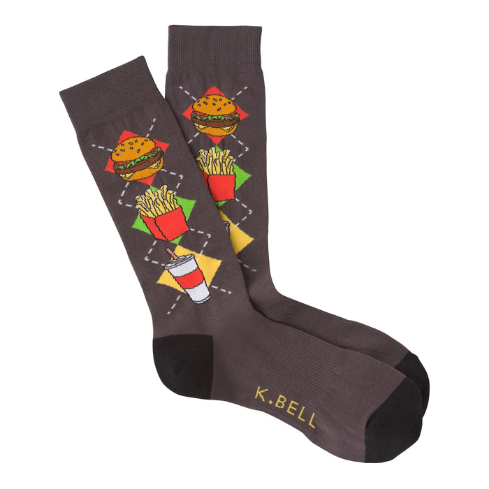 A pair of dark gray crew socks with a colorful argyle pattern of burgers, fries, and soda cups. The socks have black toes and heels.