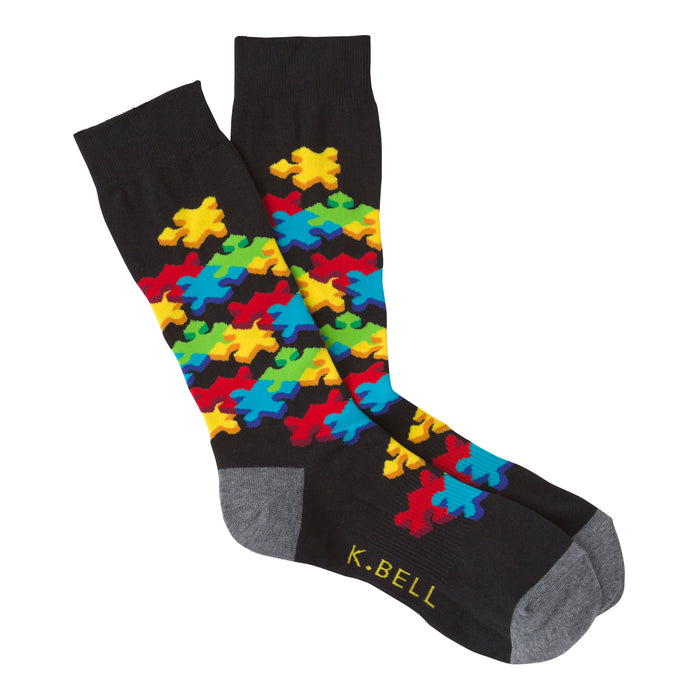 Black crew socks with a colorful 3D puzzle piece design.  Features red, yellow, blue, and green puzzle pieces.