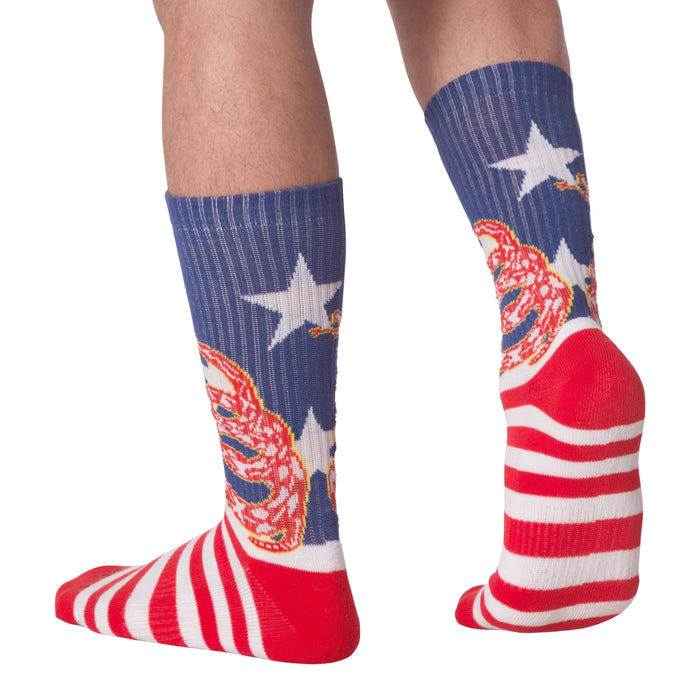 Rear view of 'Don't Tread' socks on a person's legs.