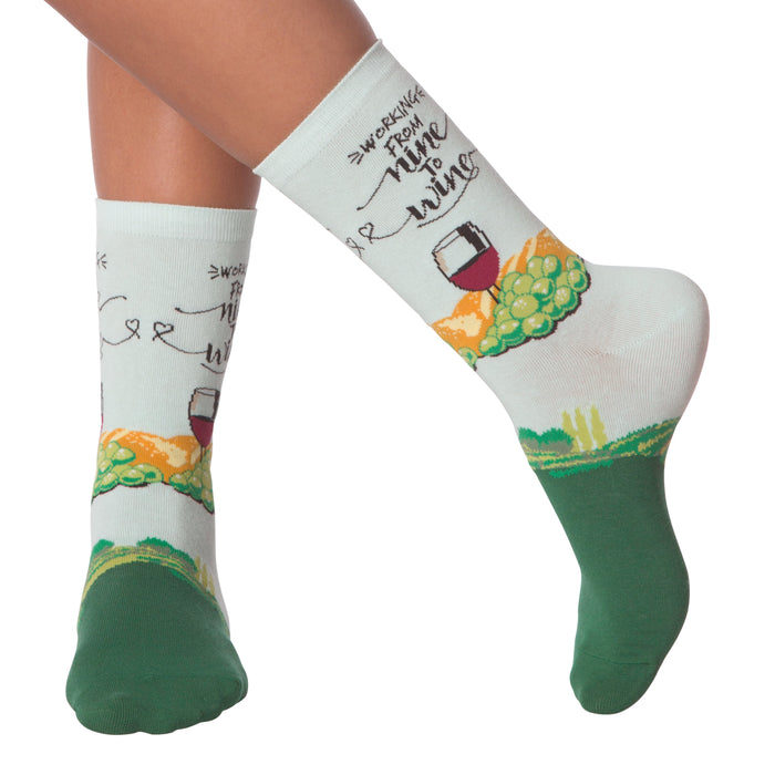 Lifestyle shot showing 'Nine to Wine' socks on a person's legs.